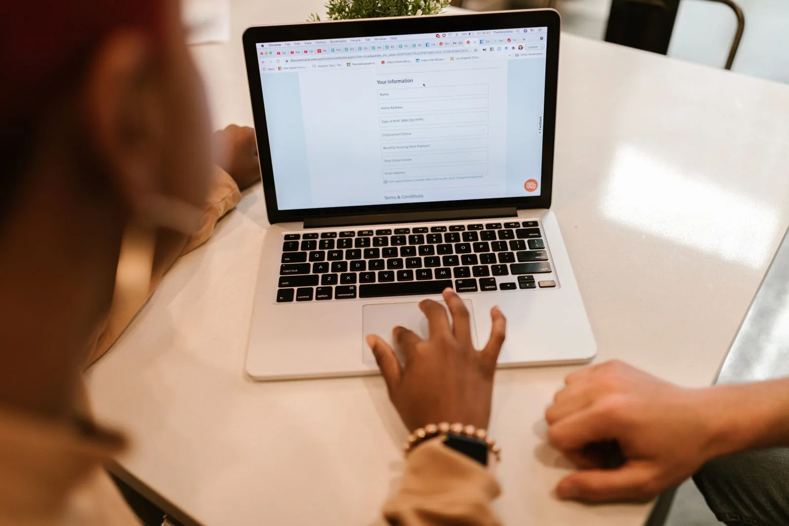 Person completing an online form on a laptop